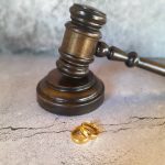 Judge's gavel with wedding ring.